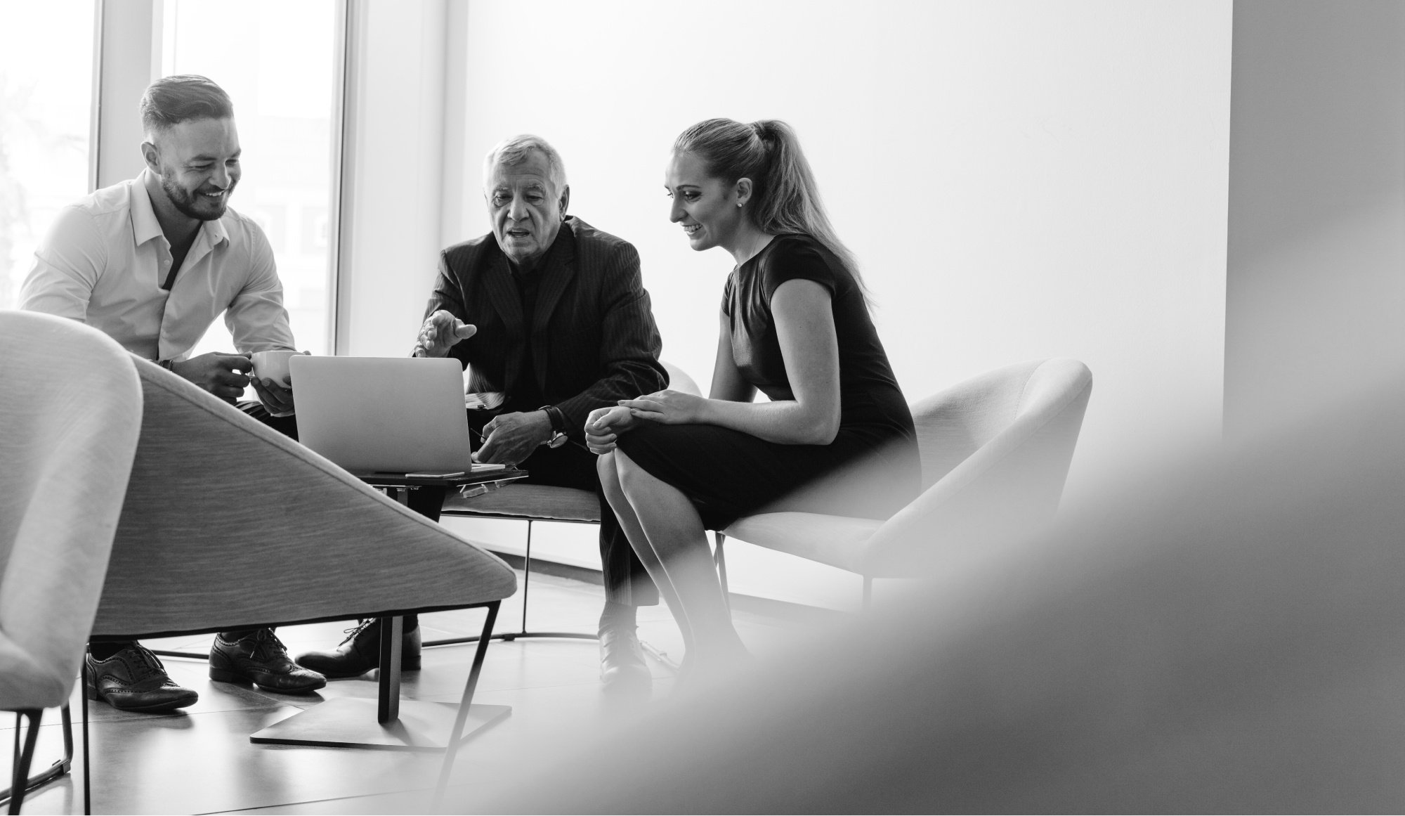 Group of business people looking at a laptop BW