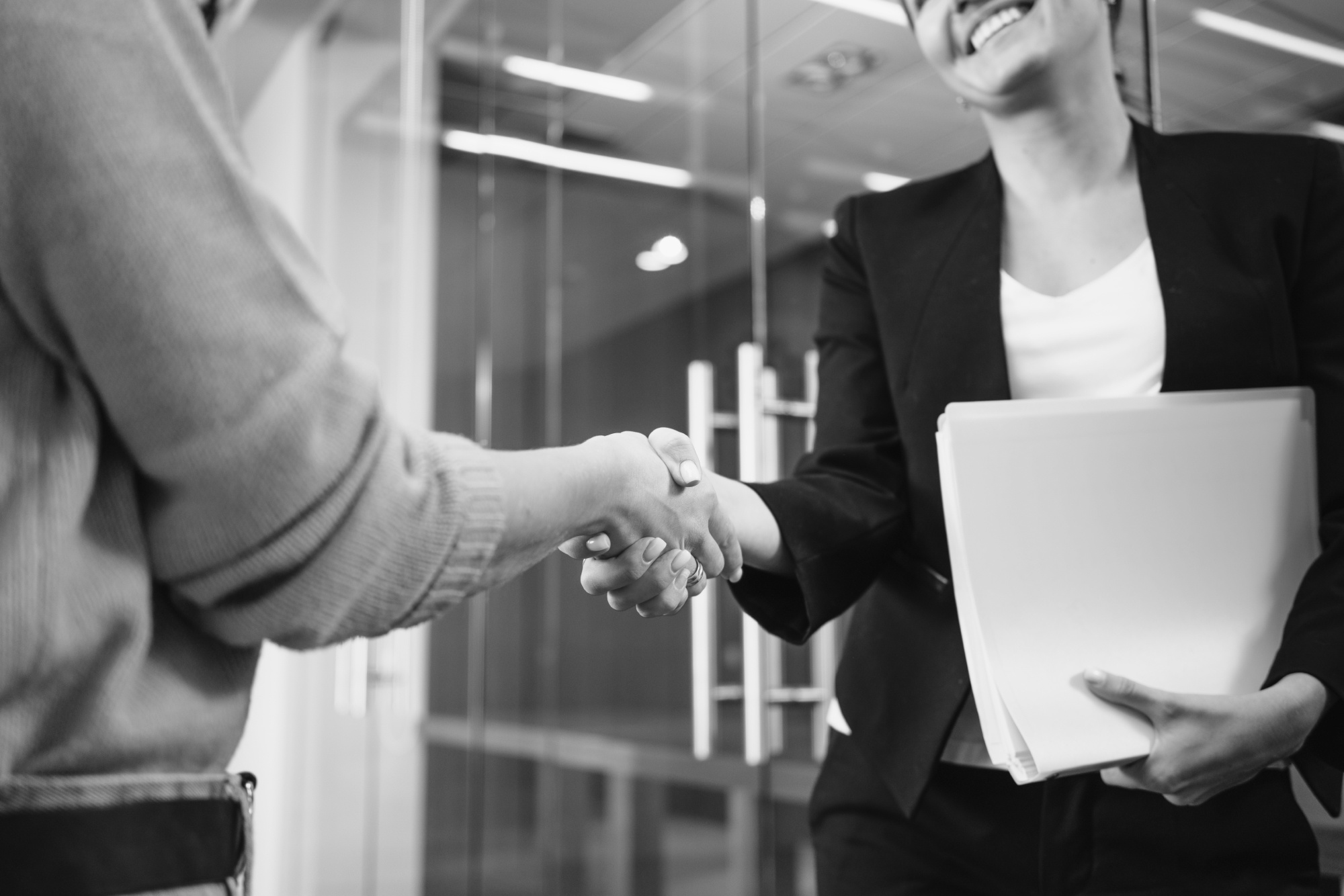 Two people shaking hands BW